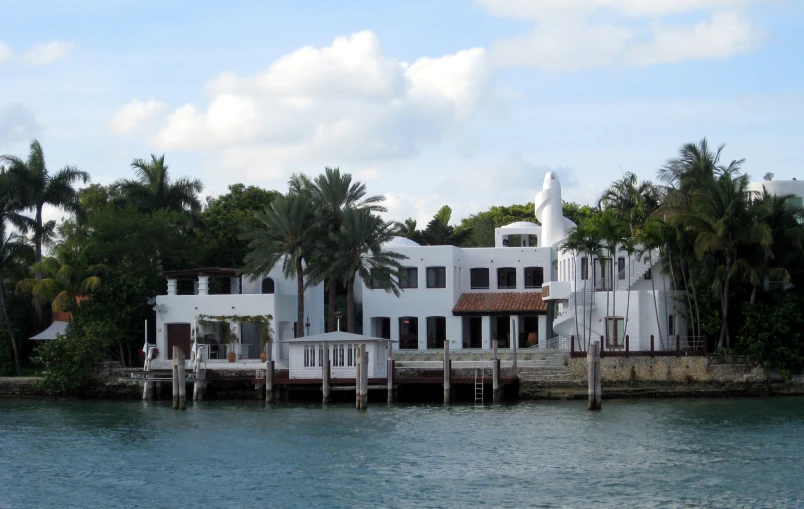 a house is shown on the side of the water