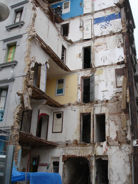 a dilapidated building with broken windows that are missing some walls