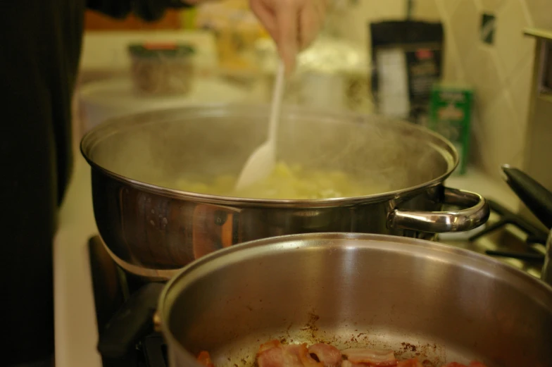 the kitchen is full of various pans that are cooking