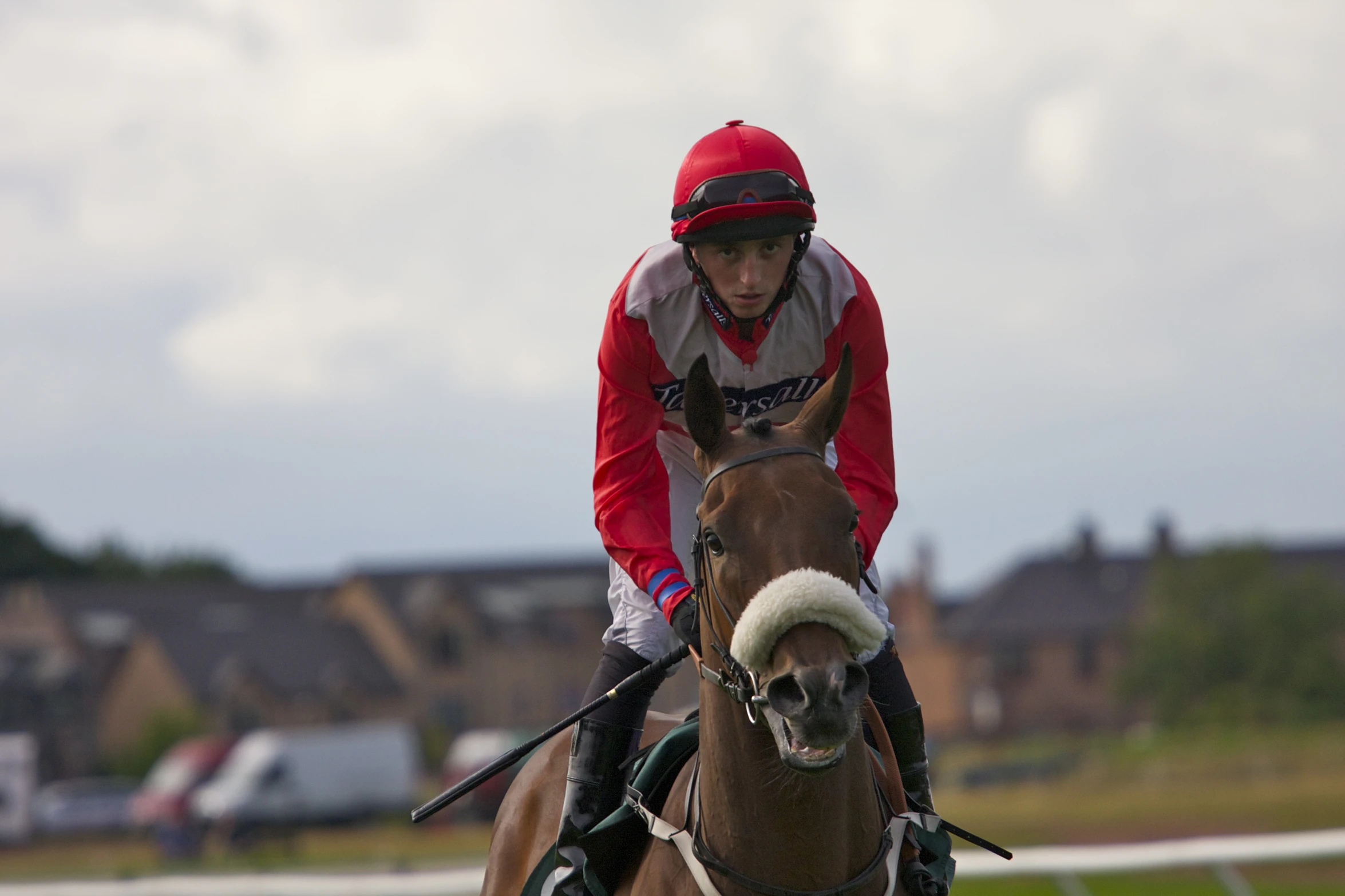 the jockey in red is on the horse