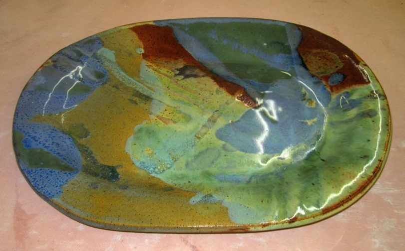 there is a green and blue decorative dish