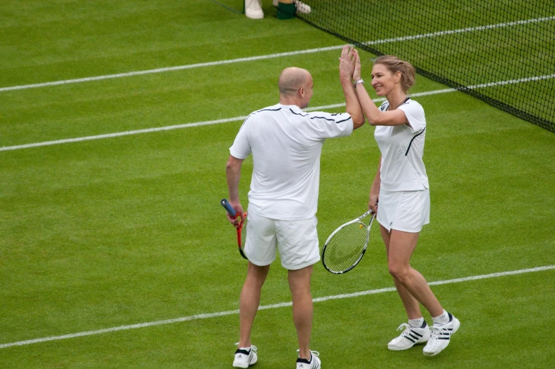 two people that are on the court holding racquets