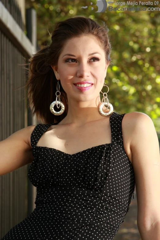 a woman is posing for a po near trees