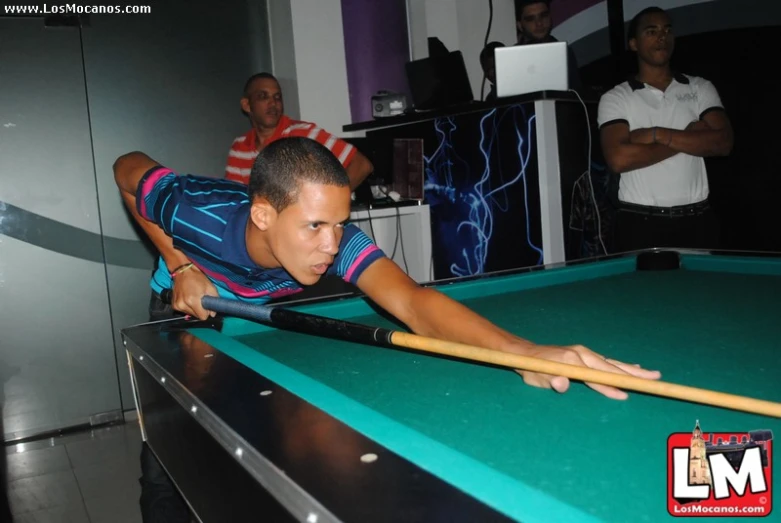 two men playing pool with one on the other side