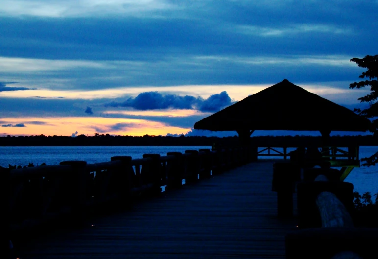 a dock sits at night by the lake