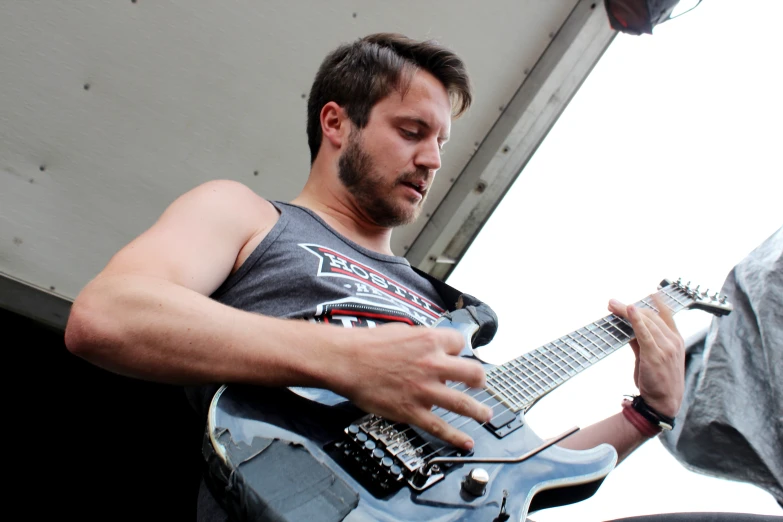 a man plays his guitar on the stage