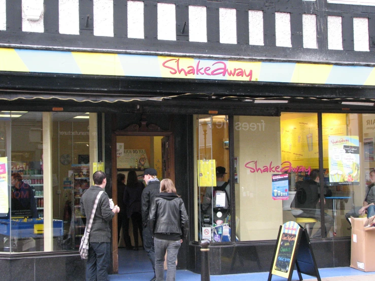 people standing outside the front of a store