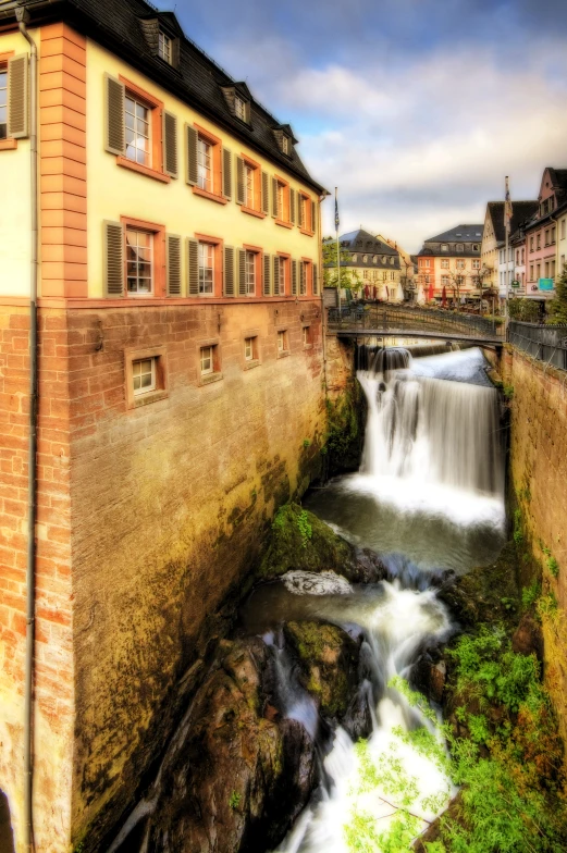 a large waterfall next to a big building