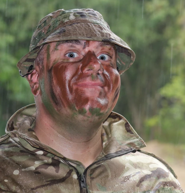 a man in camouflage wearing a hat