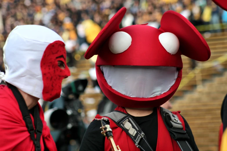 two children with red masks standing next to each other