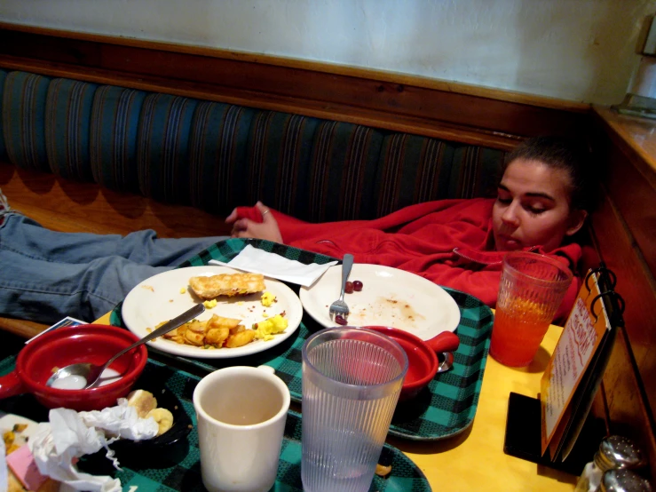 a person laying down eating from a tray