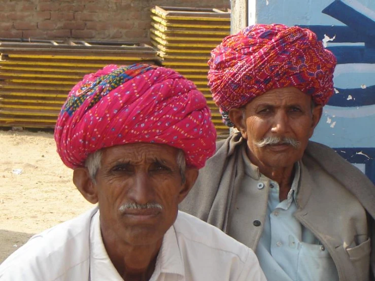 two men in turbans and hats on the streets