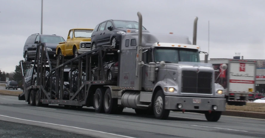 two trucks on a road with other cars in the background