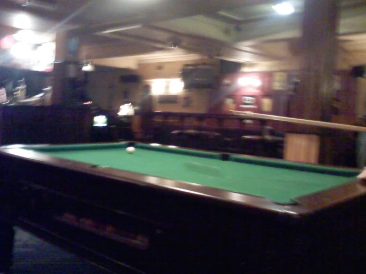 a green pool table sitting in a room