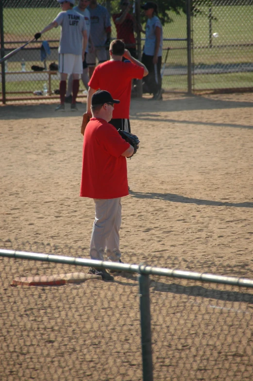 s play baseball in a coral colored uniform