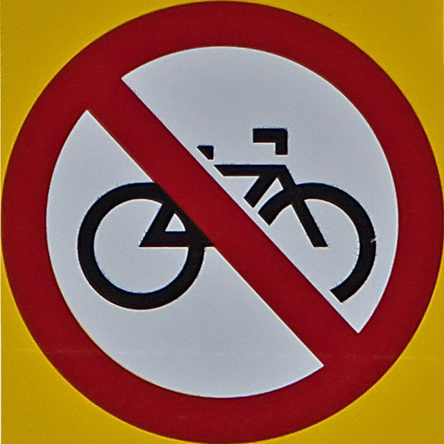 a yellow and red sign that says, no bikes allowed