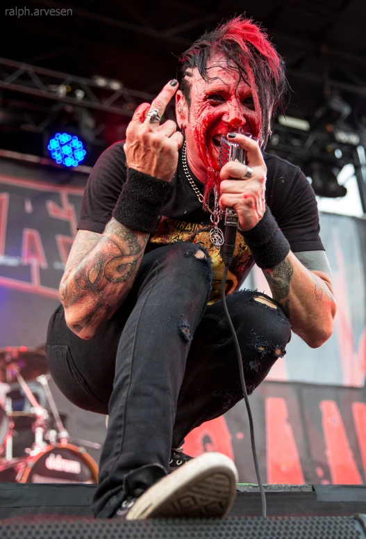 a young man with tattoos and tattoos on performing