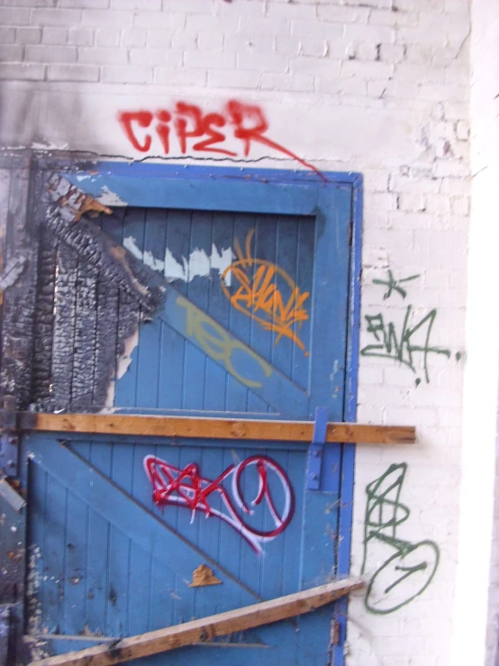 this is a pograph of a door with graffiti on it