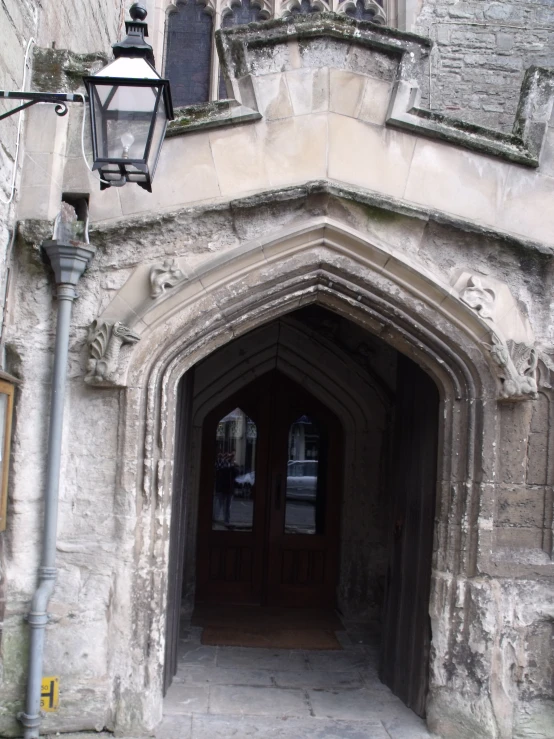 a stone building with two large black doors