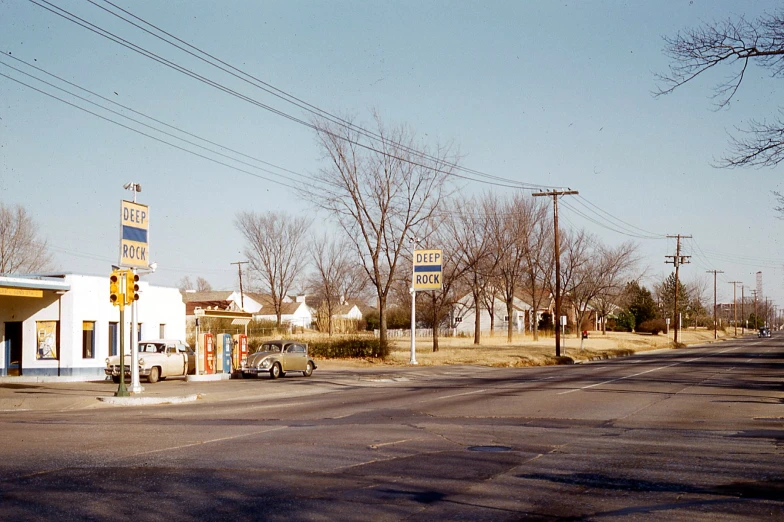 an empty street next to a business with a gas station