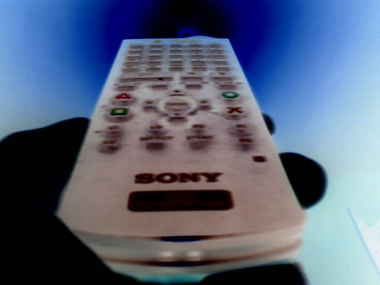 a person is holding a remote control pointed at it