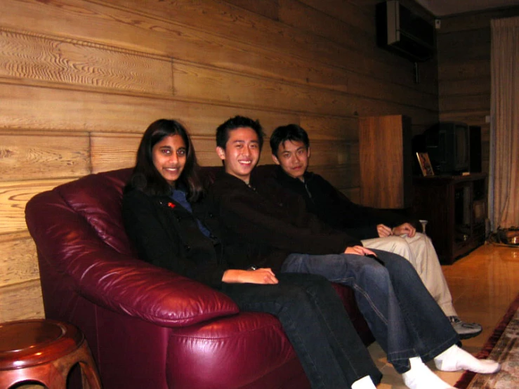 four young people posing for a po on a couch