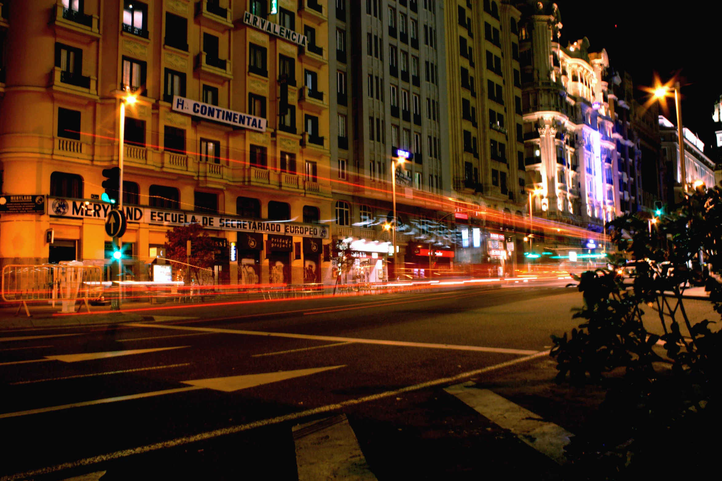 a city street that is lit up with bright lights