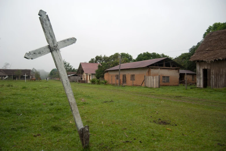 a sign in front of an old building is displayed on grass