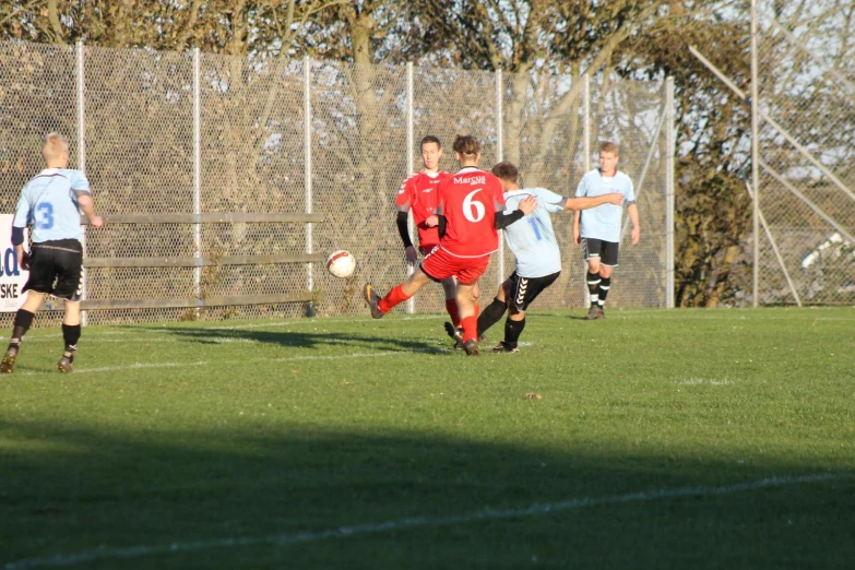 a group of young people playing a game of soccer