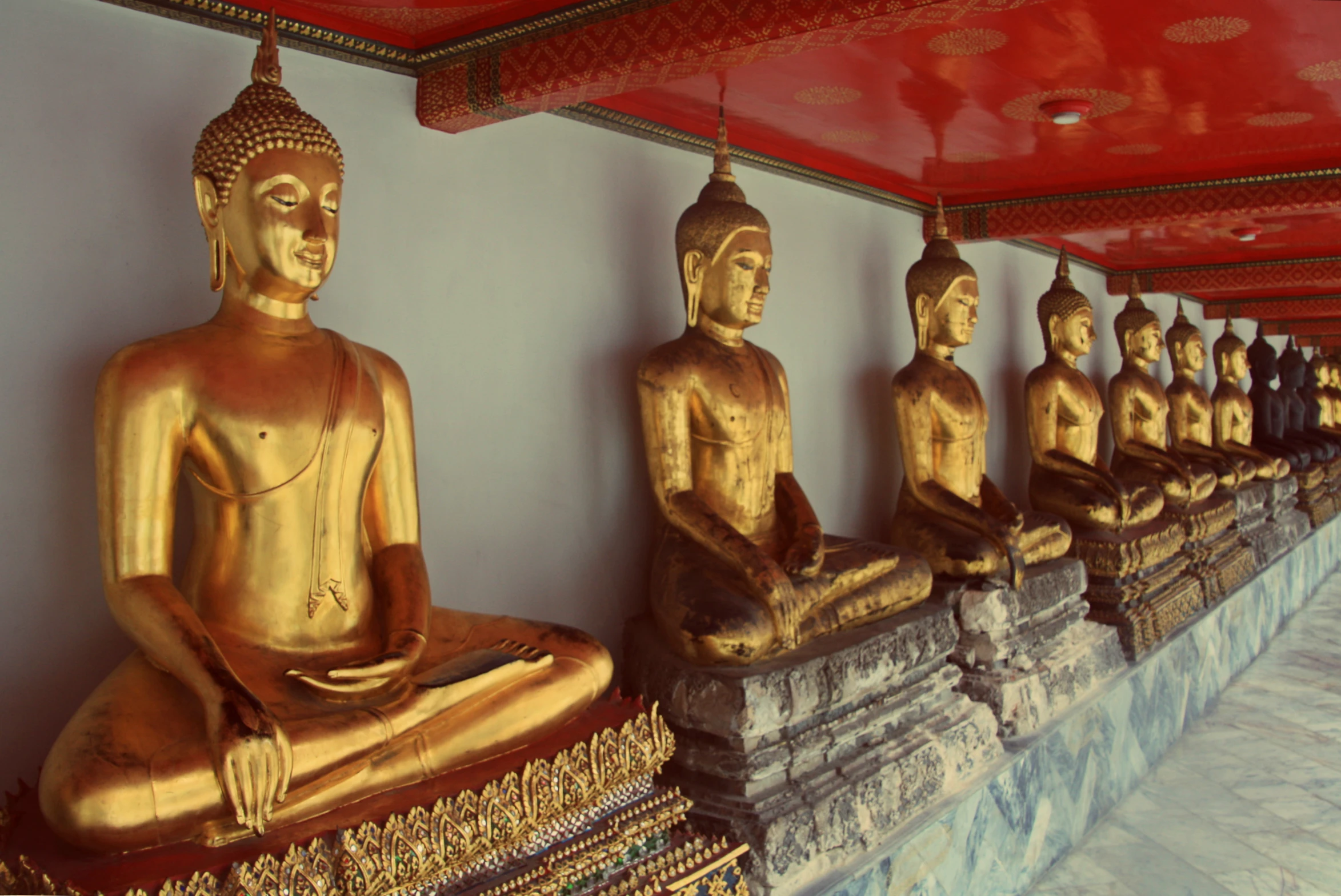 golden statues line the walls of a temple