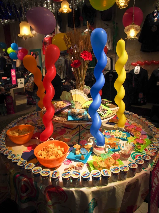 a very colorful table set up for a birthday
