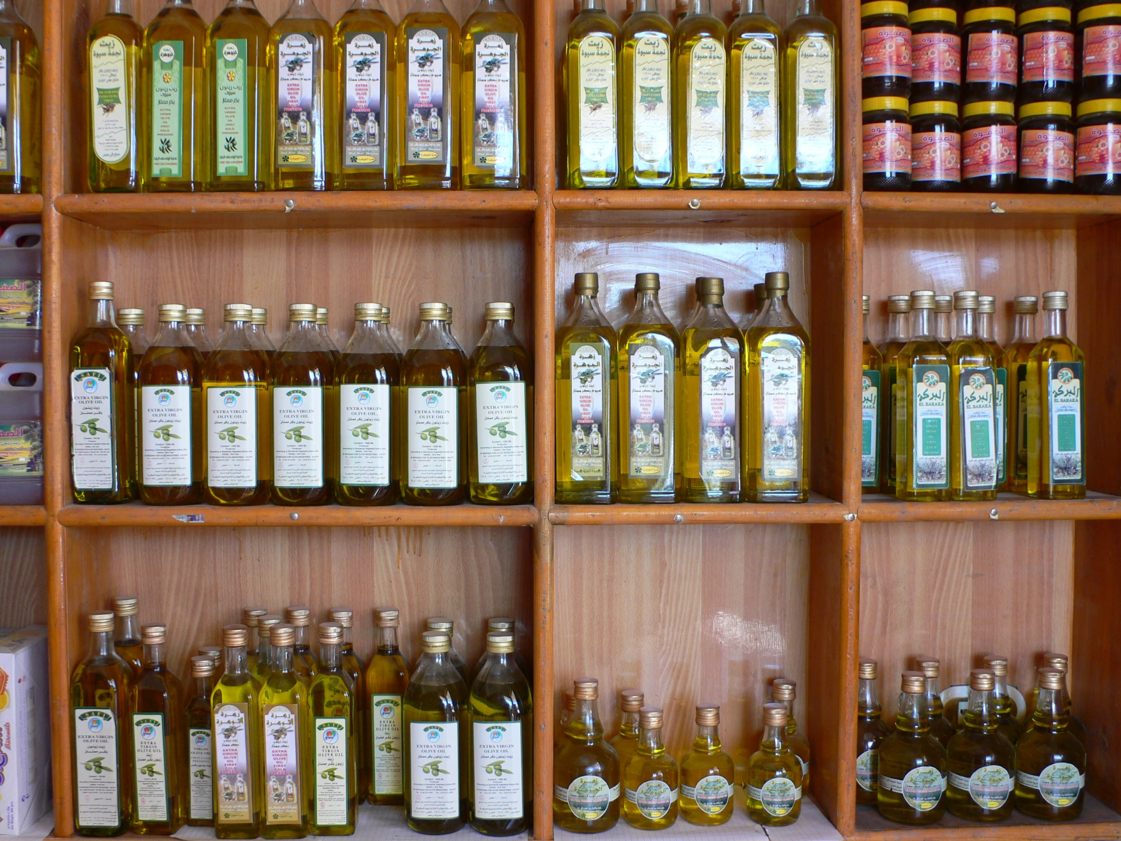 a wood shelf with lots of bottles filled with liquid