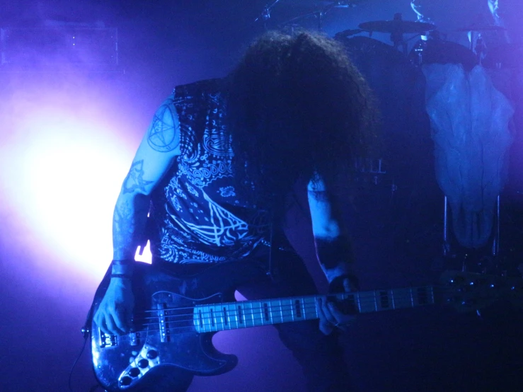 an image of a man playing a guitar at a concert