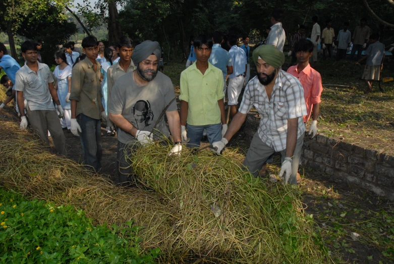 a large group of people standing in front of a field