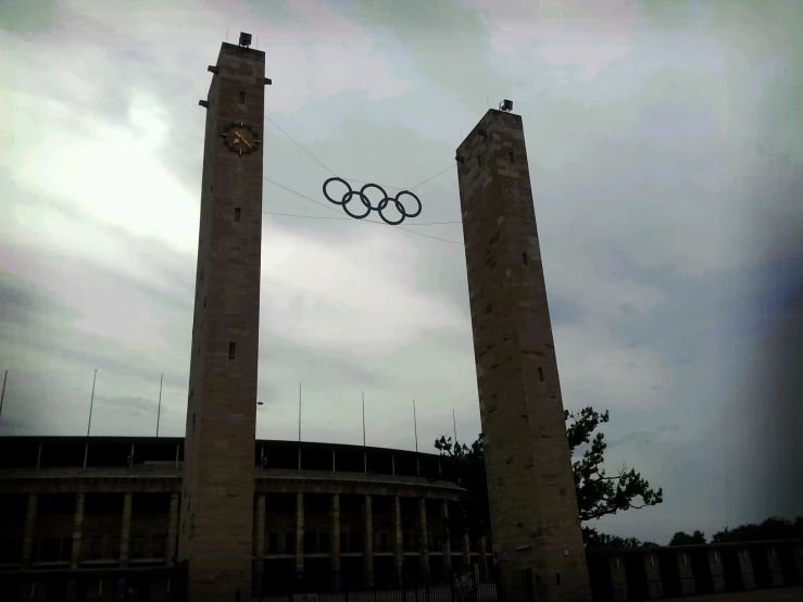 two tall towers are in front of a cloudy sky