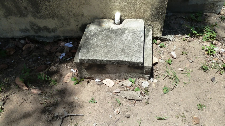 an empty cement box next to a wall