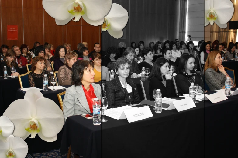 people seated at a banquet with black table cloths