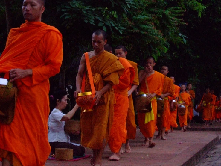 a group of monks are lined up near a park