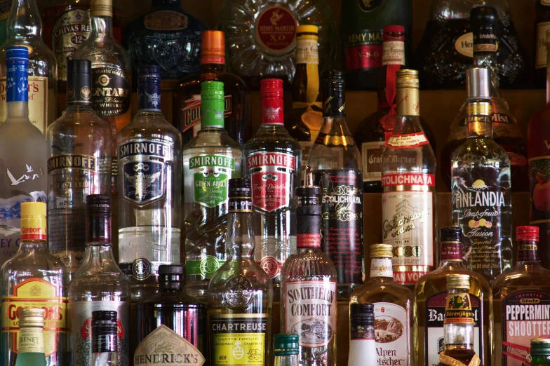 several bottles are lined up in front of a wall