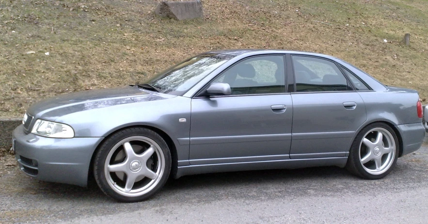 a grey car sitting in a parking lot