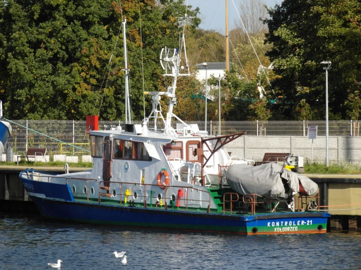 a boat in the water docked near a pier