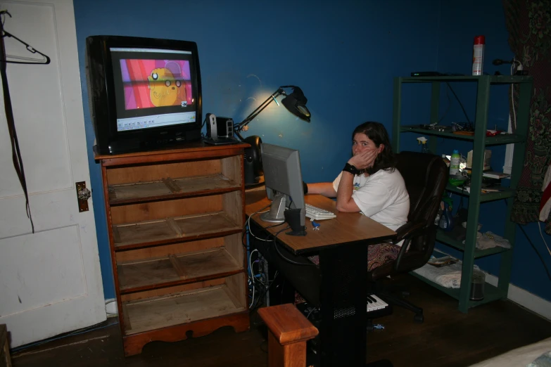 a woman is sitting in front of a tv with a video game