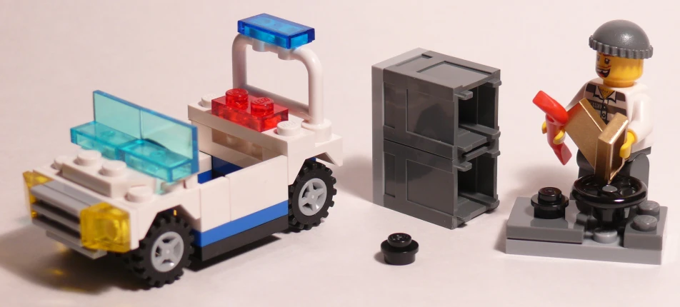 a lego policeman with police car and man holding a saw