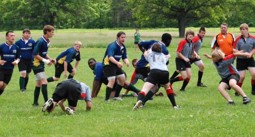 group of people standing in a field playing soccer