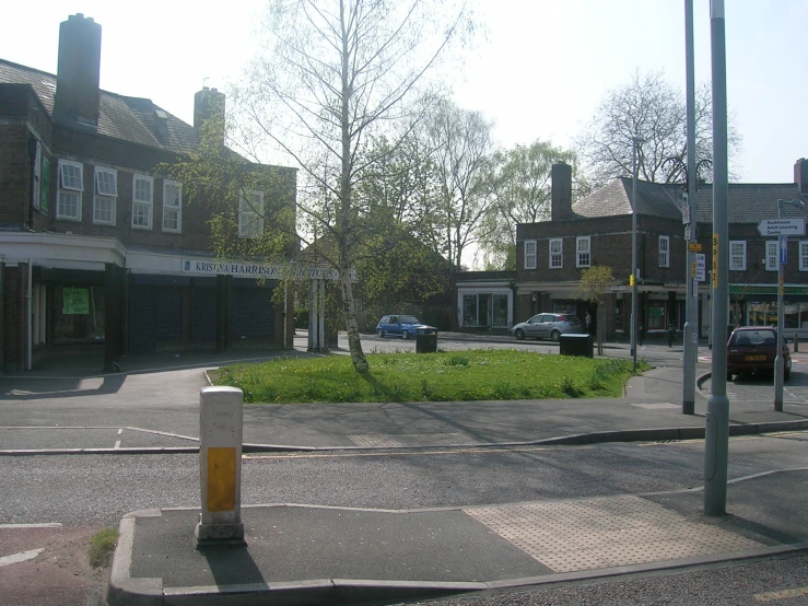 an intersection with shops and a lot of cars on it