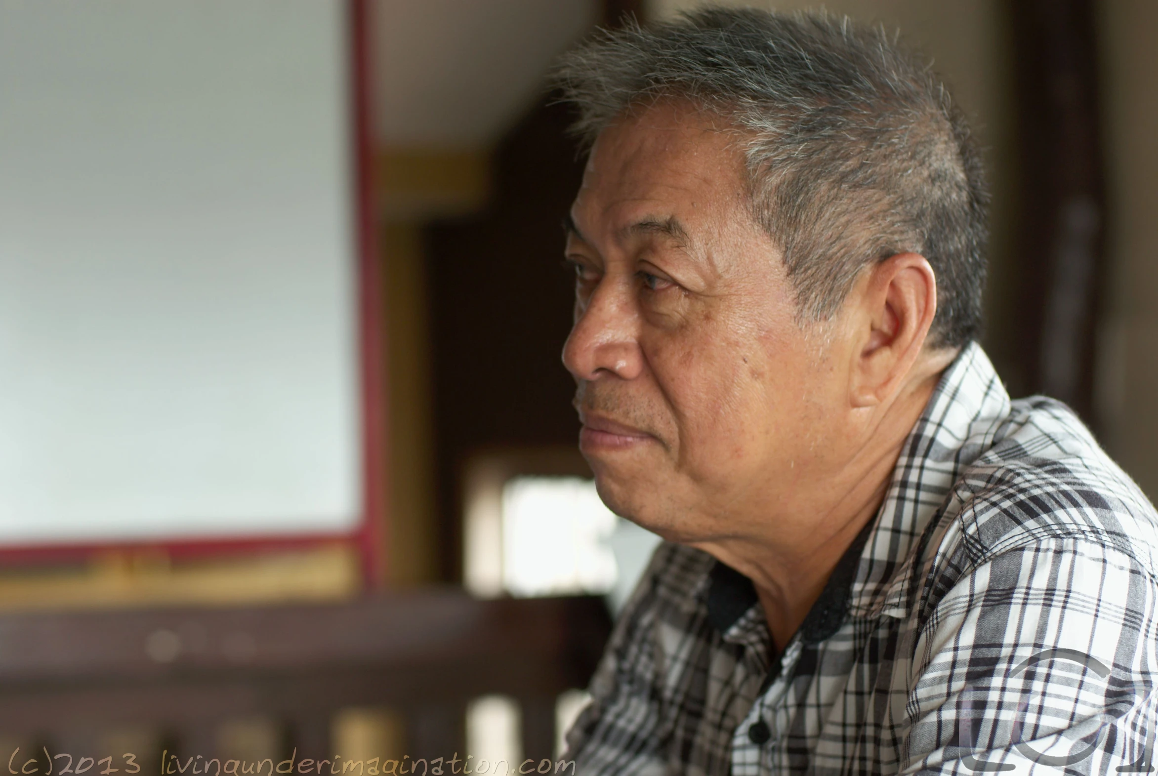 an older man looks on as the person in his chair watches him