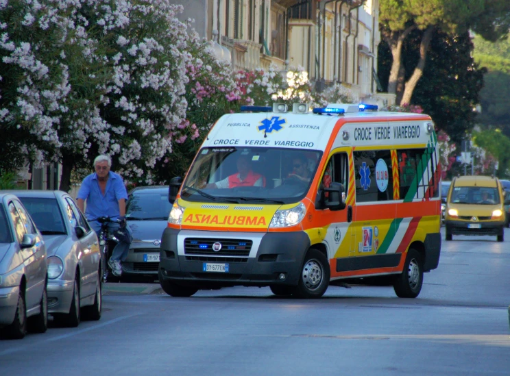 a small ambulance driving down the street