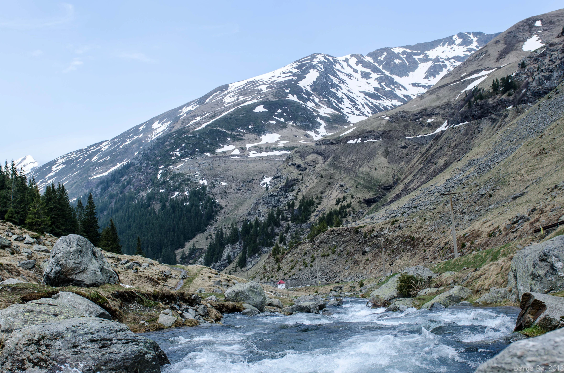 the view of the mountains as it stands over a mountain river