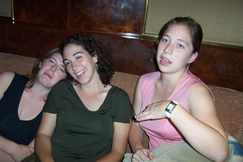 three young women pose together for a po