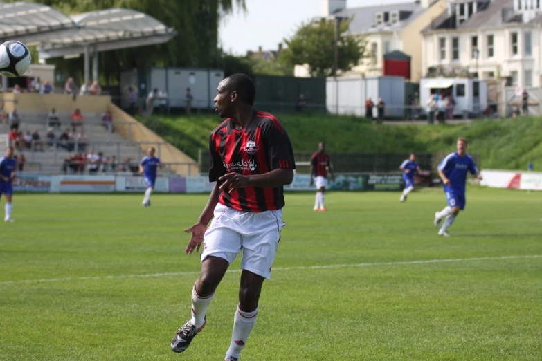 a soccer player is kicking the ball in the air